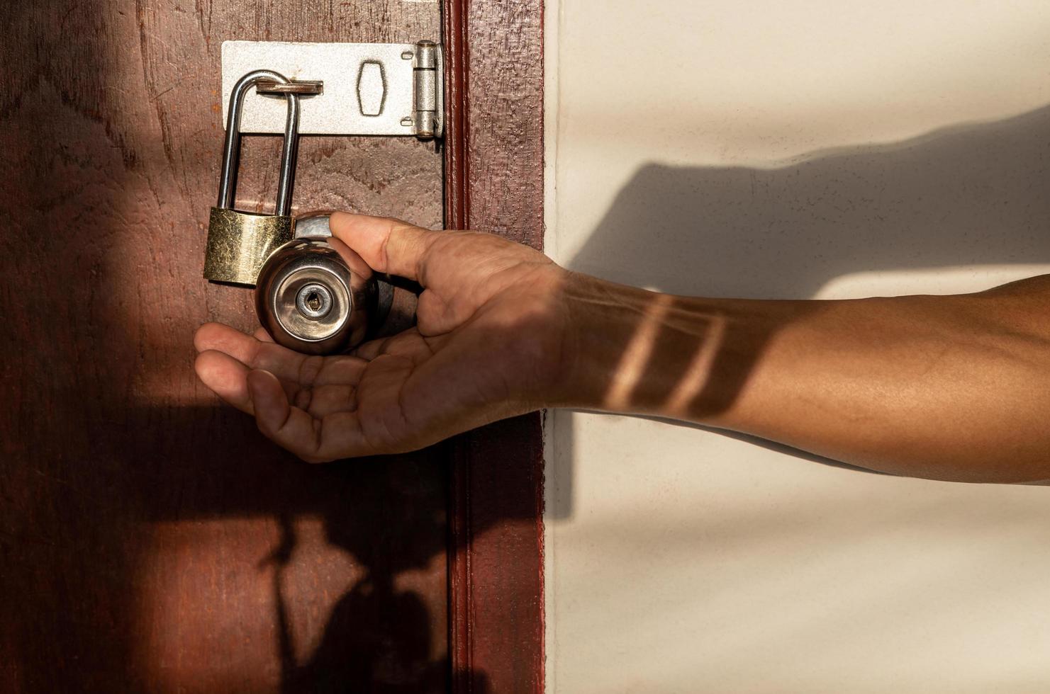 A close-up view of a hand holding a doorknob trying to open i. photo