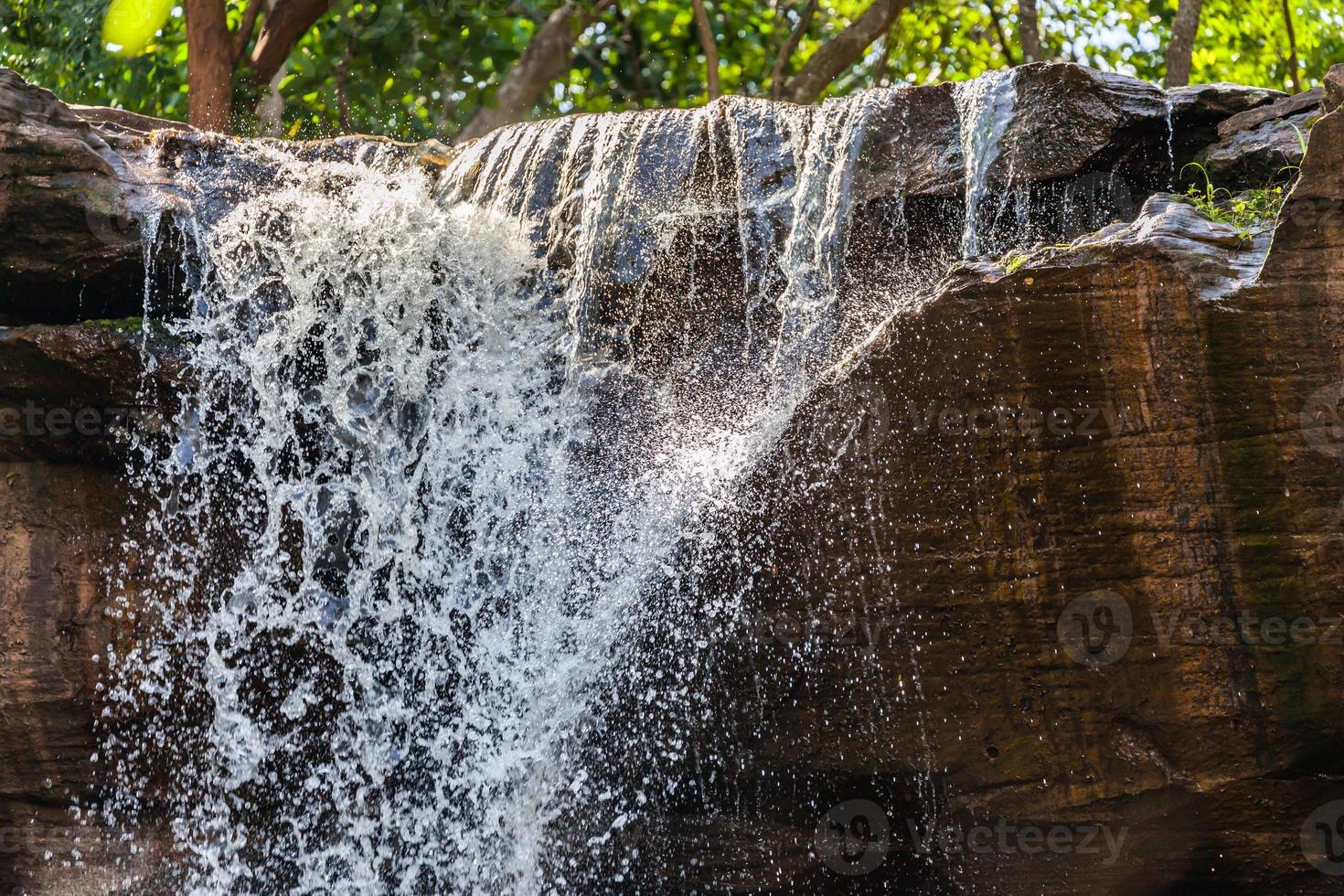 Tropical waterfall in rain forest photo