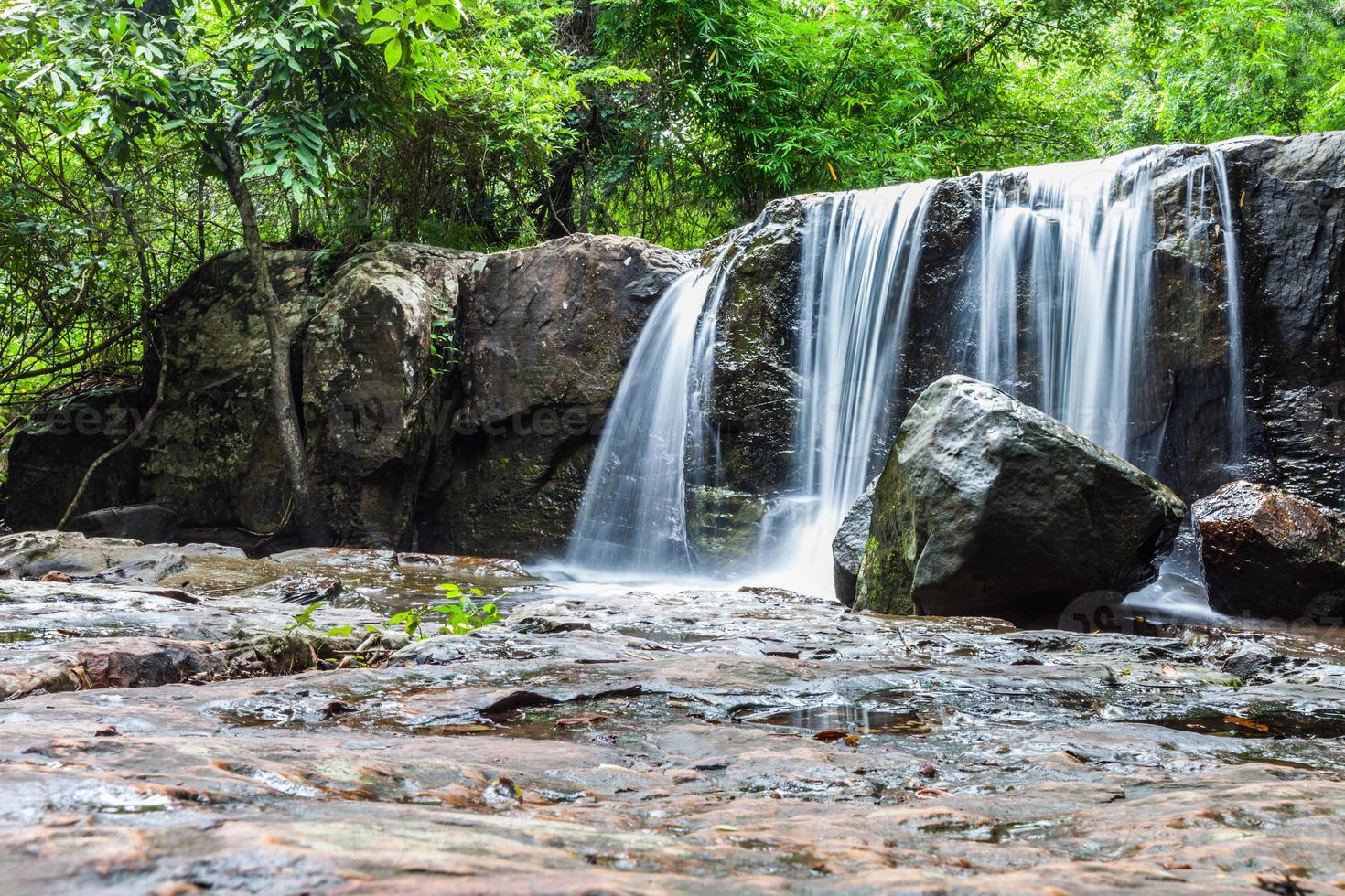 Tropical waterfall in rain forest photo