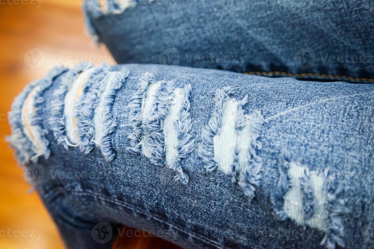 leg of women in fragmentary and torn jeans photo