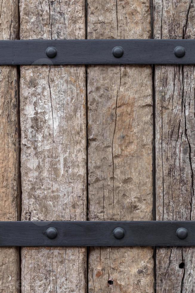 Background of old logs, which are fixed with steel. photo