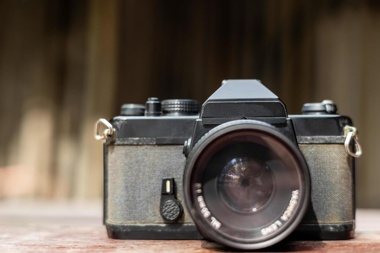 In front of an old black film camera with a red towel. photo