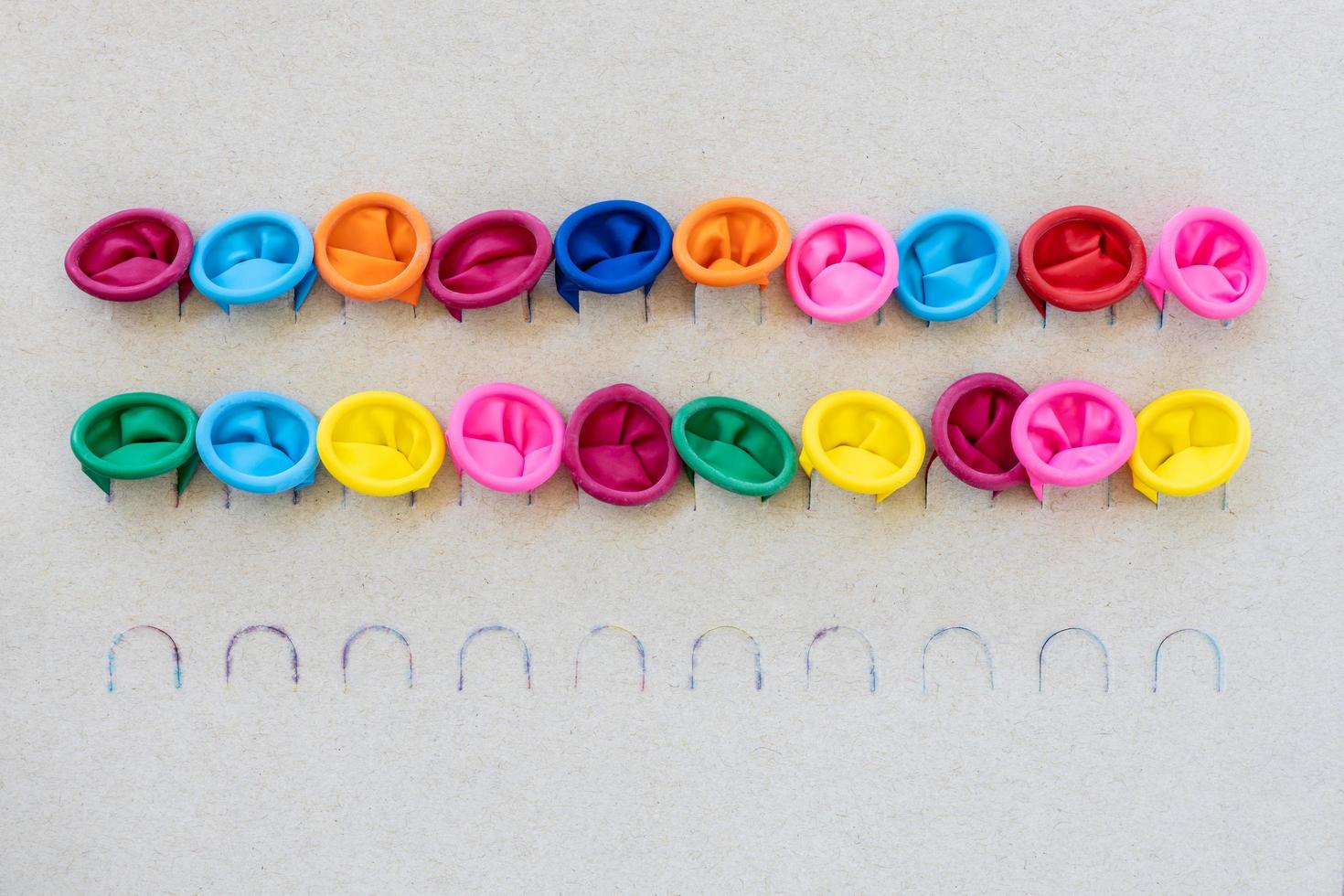 Various colors of the mouth of balloons plugged into the dull paper. photo