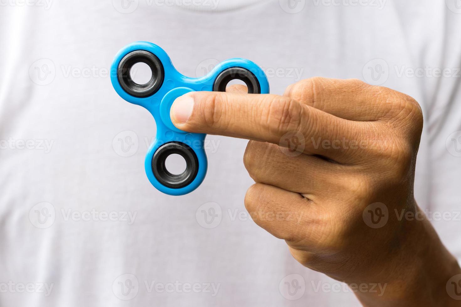 Close-up of a spinner in fingers. photo
