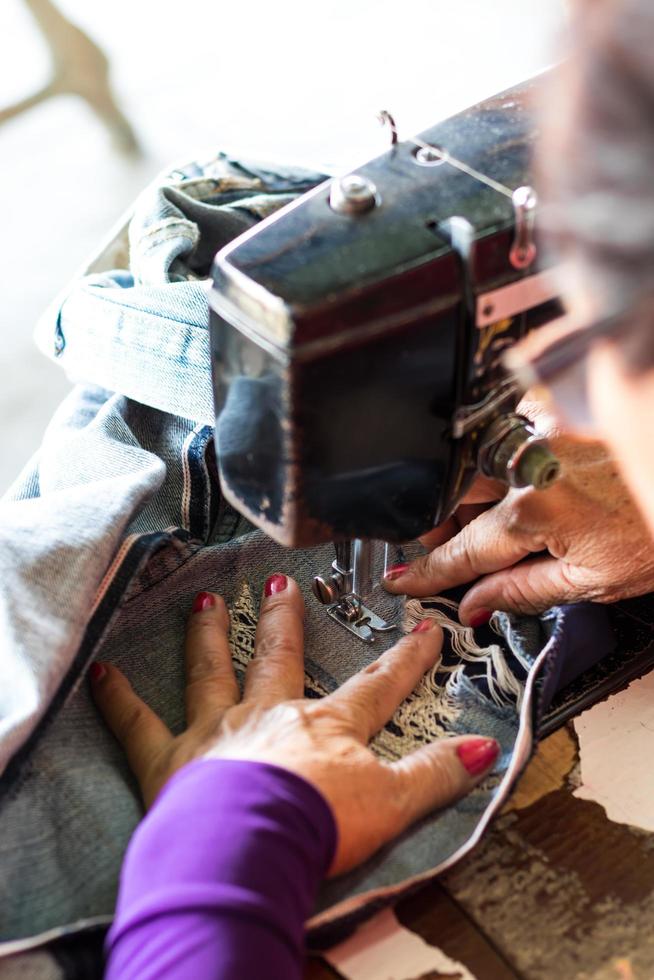 Female sewing repair jeans. photo