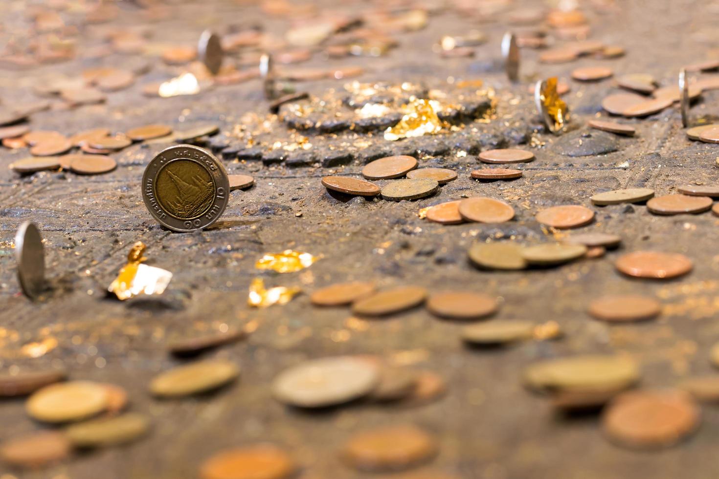 Many old coins on the ancient altar. photo