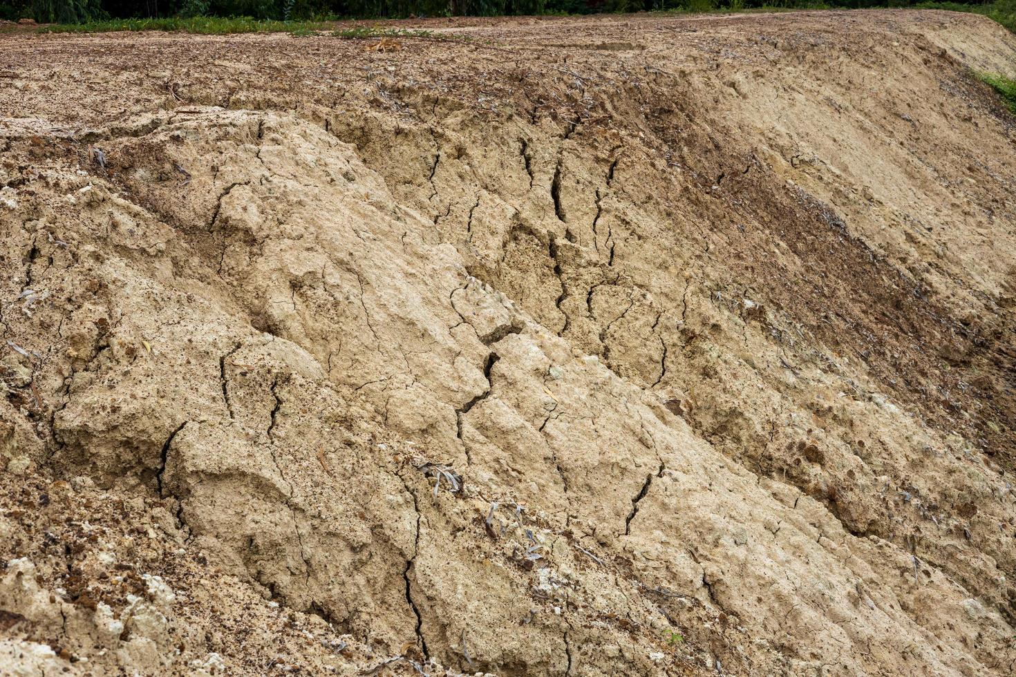 The mound of the dirt road has been eroded until it collapses. photo