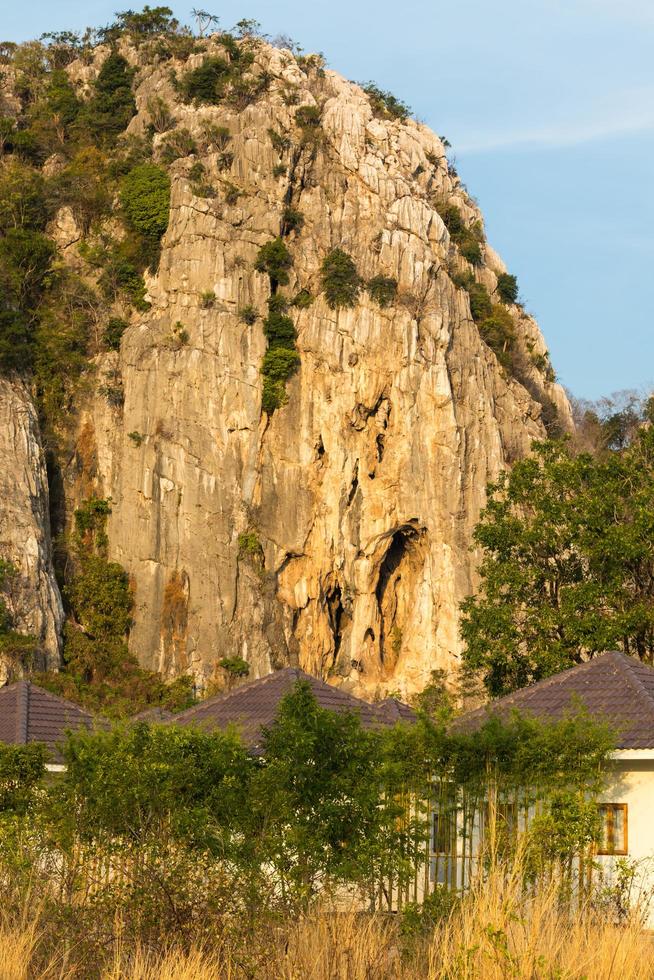 Cottage near the cliff mountains. photo