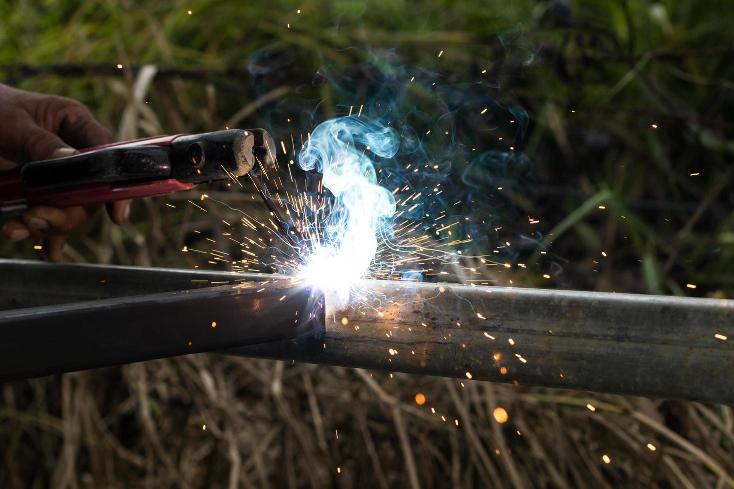 Sparks and smoke welding iron. photo