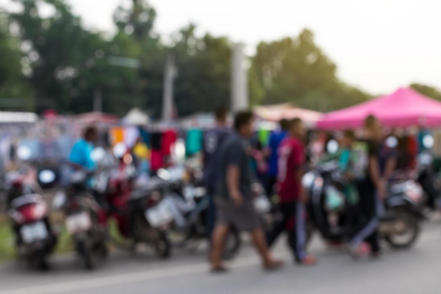 Blurred people walking near the motorcycles. photo