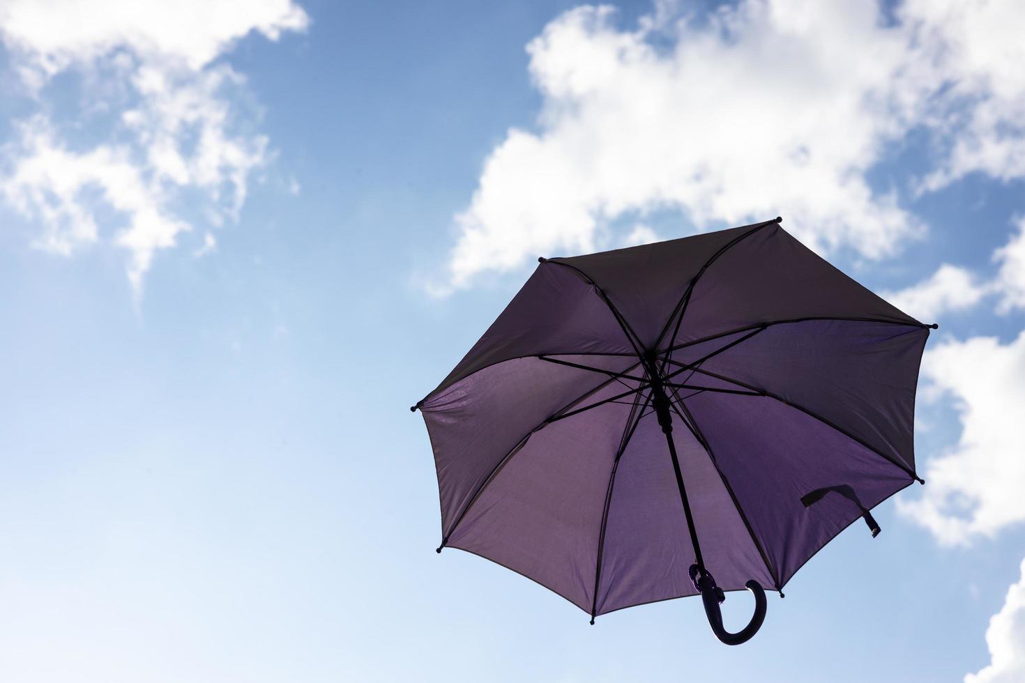 A close-up view from the low, a beautiful purple umbrella floating freely. photo