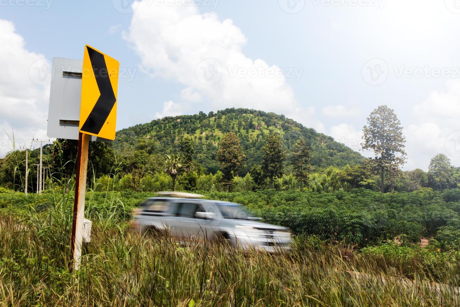 Signs curve with cars blurred hill. photo