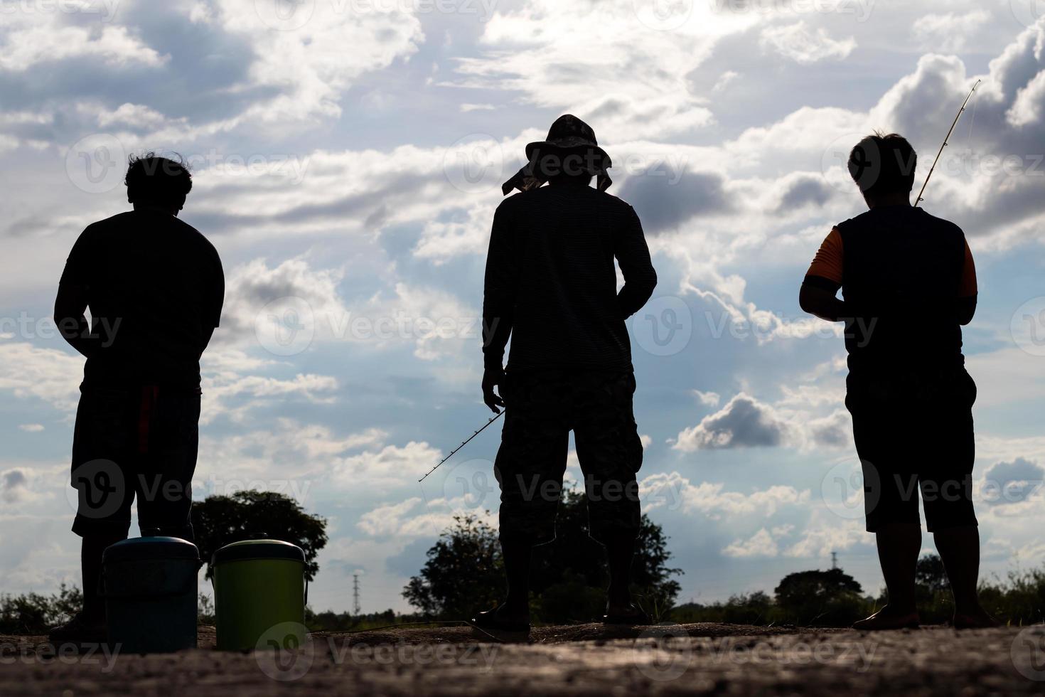 Silhouette behind the fisherman. photo