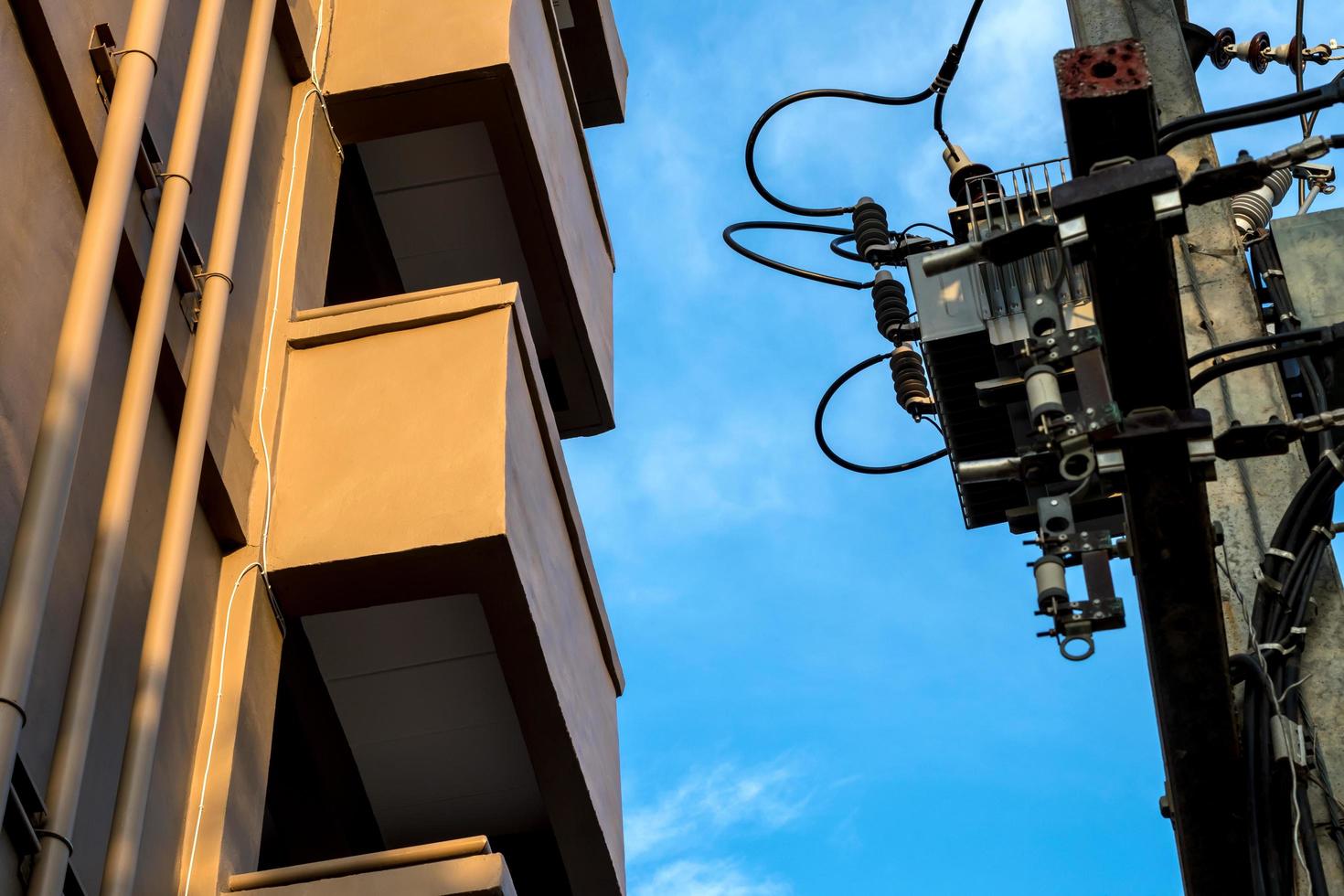 Terrace building near transformer with sky. photo