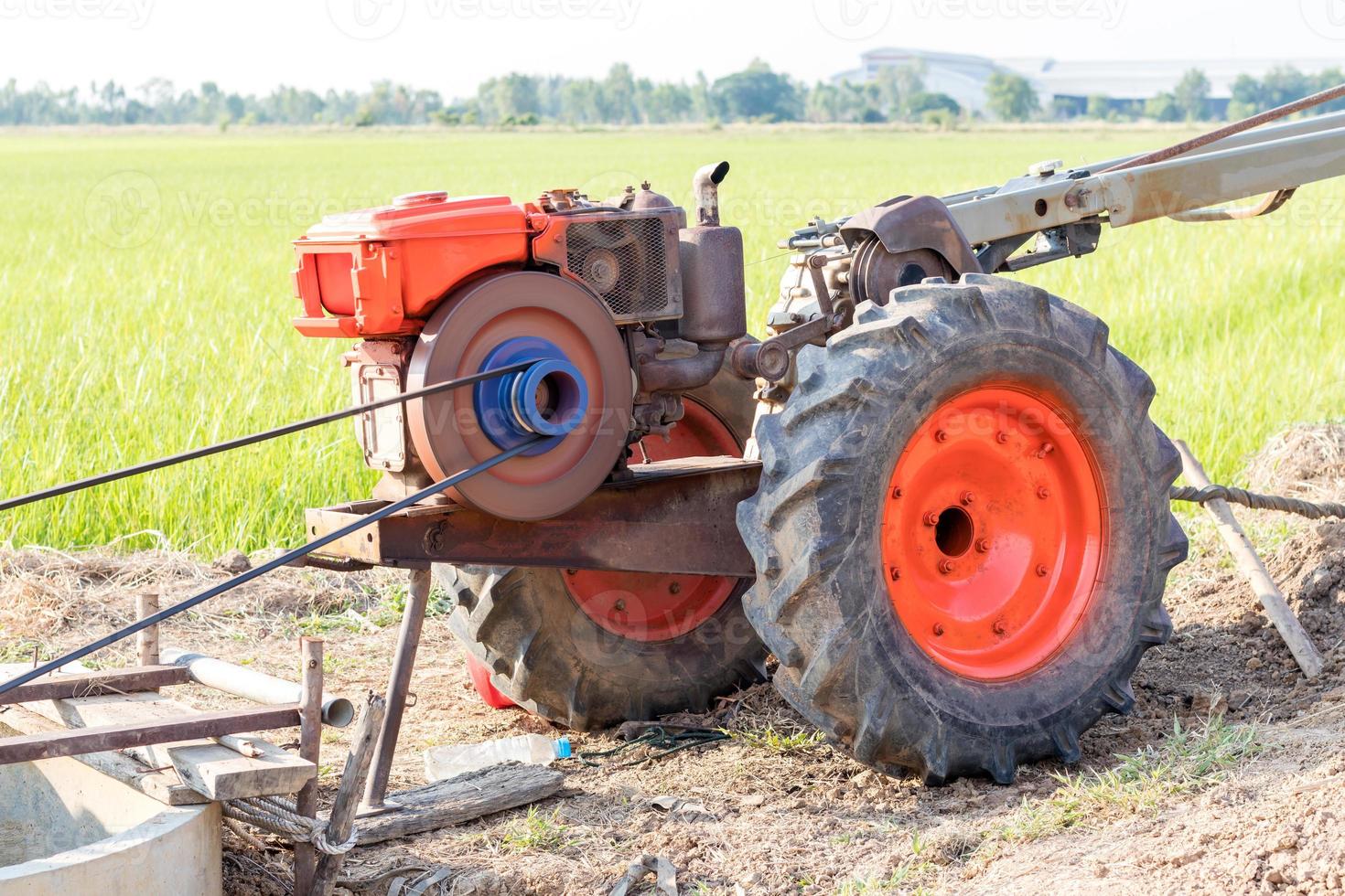 Agricultural engine pumping into rice paddy fields. photo