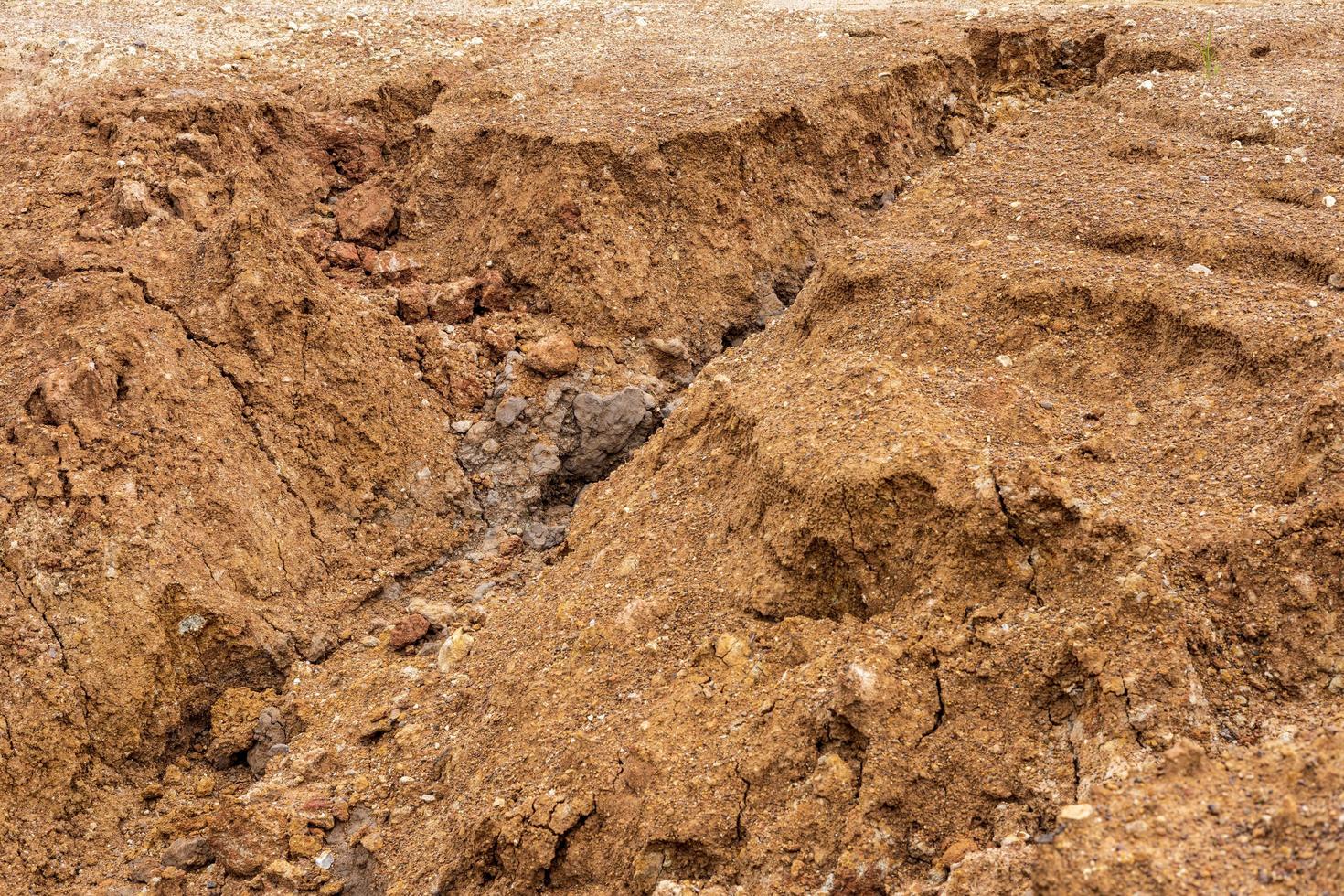 The mound of the dirt road has been eroded until it collapses. photo