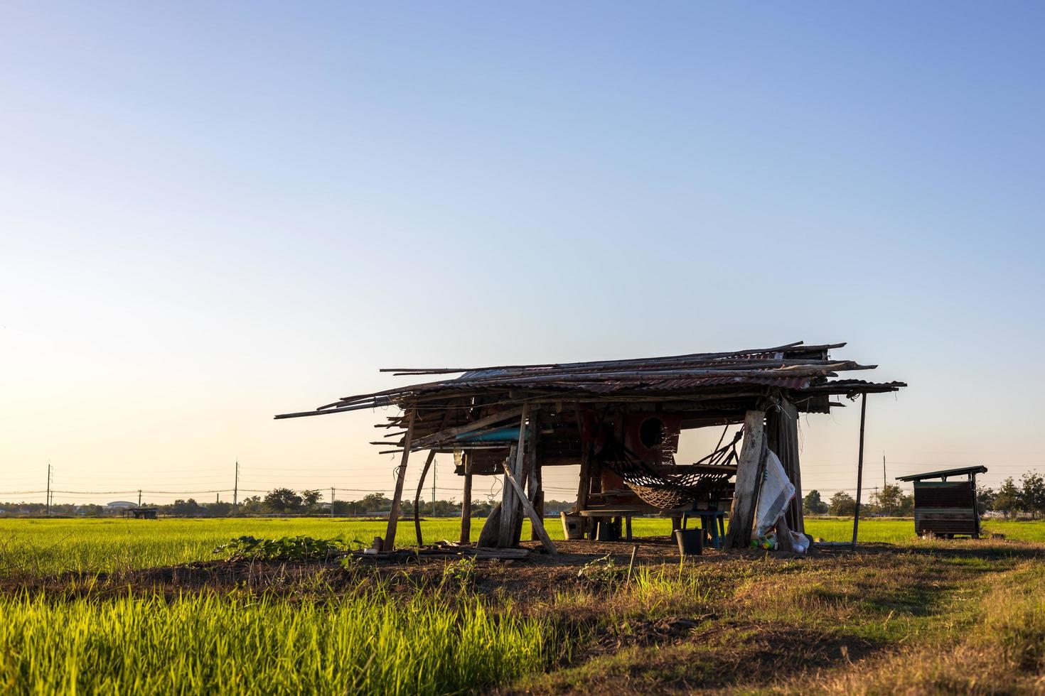 Low angle view, old wooden and zinc huts mounted on a barren brown mound. photo