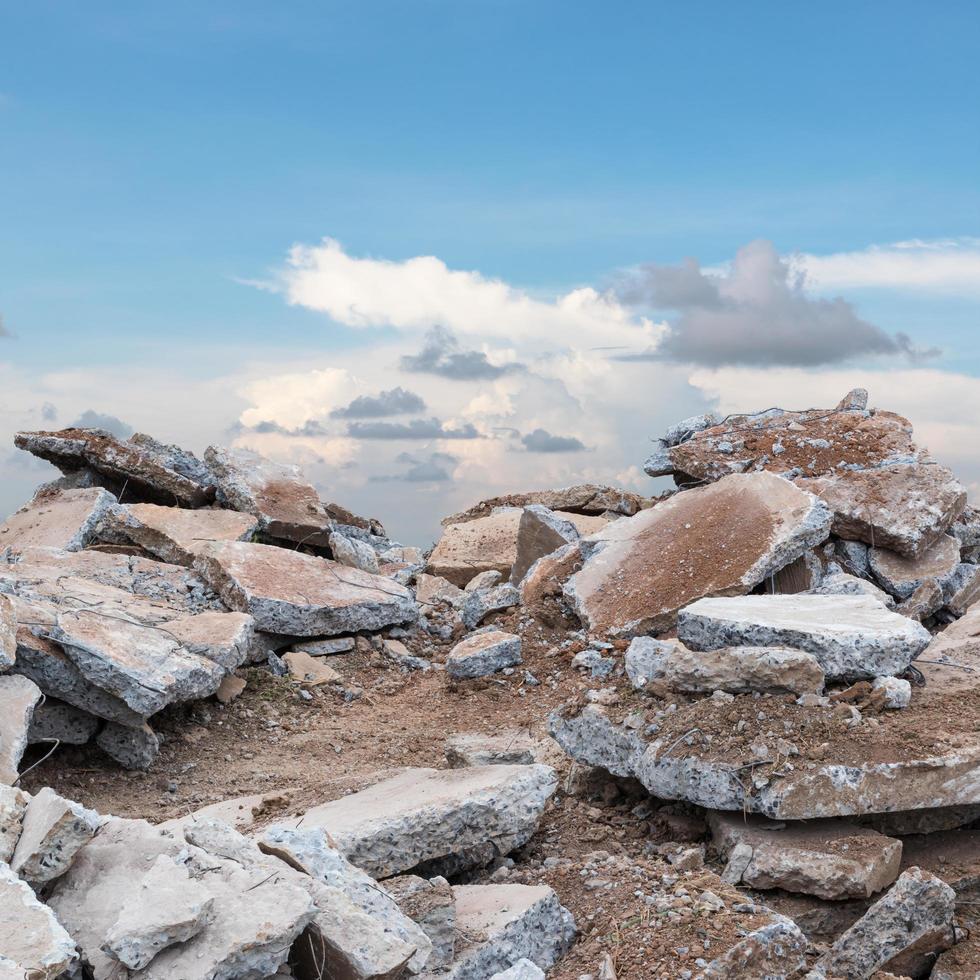 Stack of concrete debris with sky clouds. photo