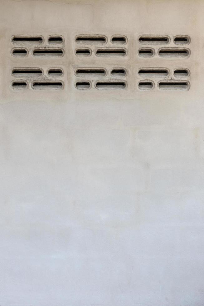 Cement wall with brick ventilation vents. photo