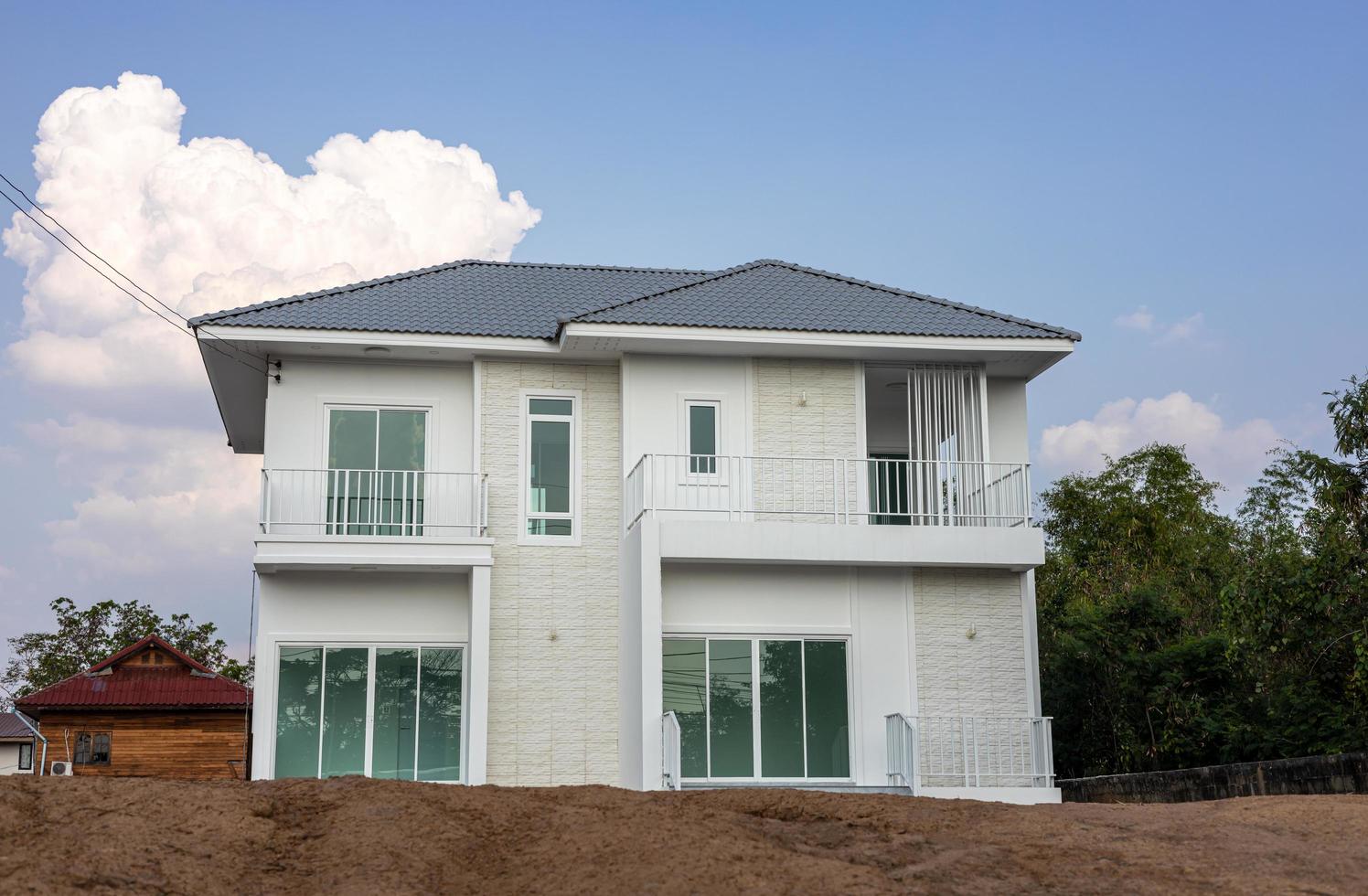 A low angle view of a beautiful white large new house erected. photo