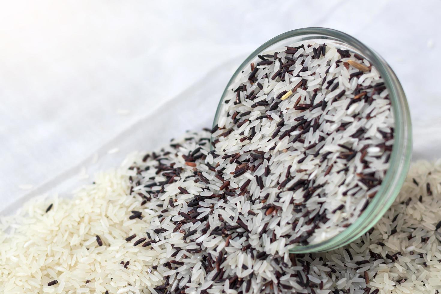 White rice with black overflow cup and upside down on the cloth. photo