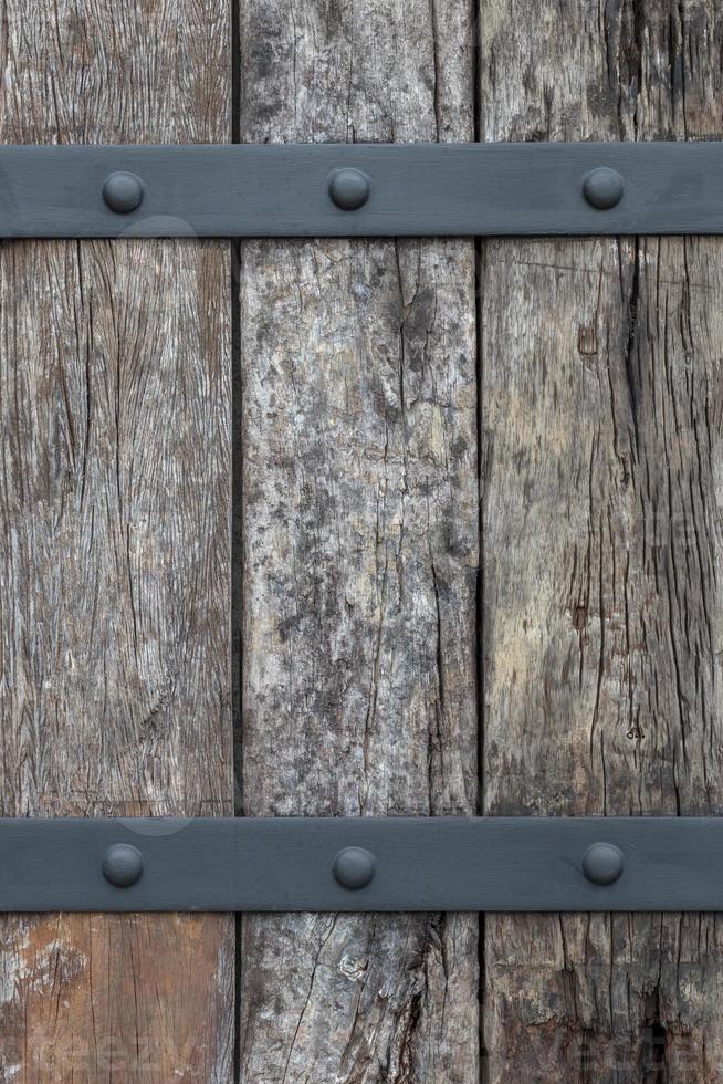 Background of old logs, which are fixed with steel. photo