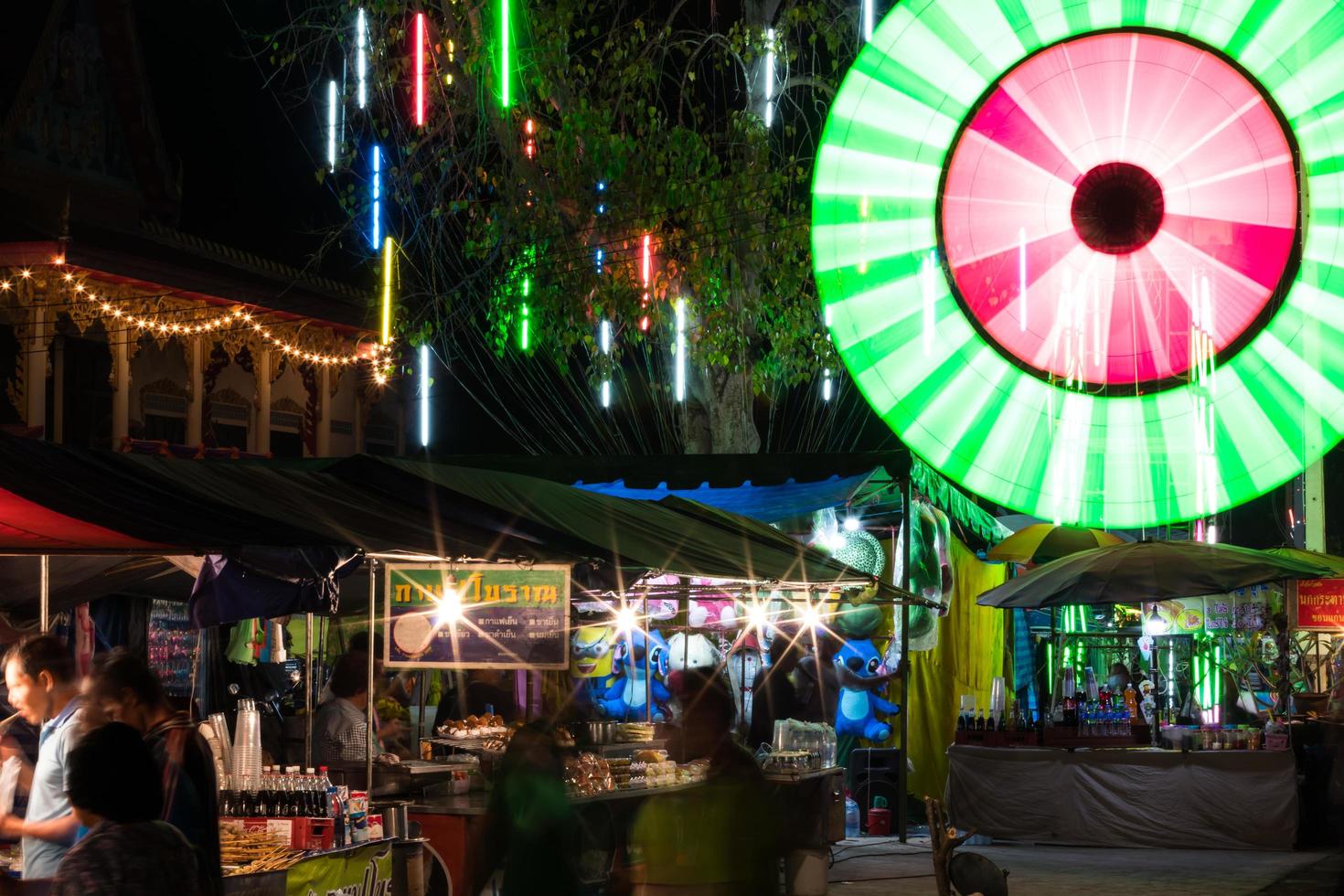 Colorful lights spin over people stores. photo