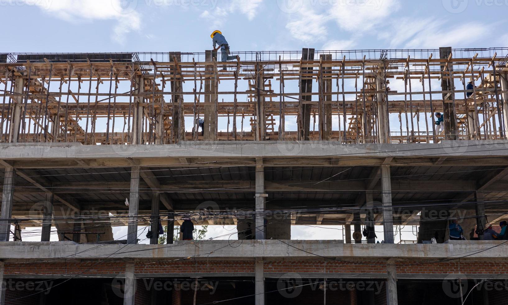 A view from below to the construction of a rowhouse building anchored. photo