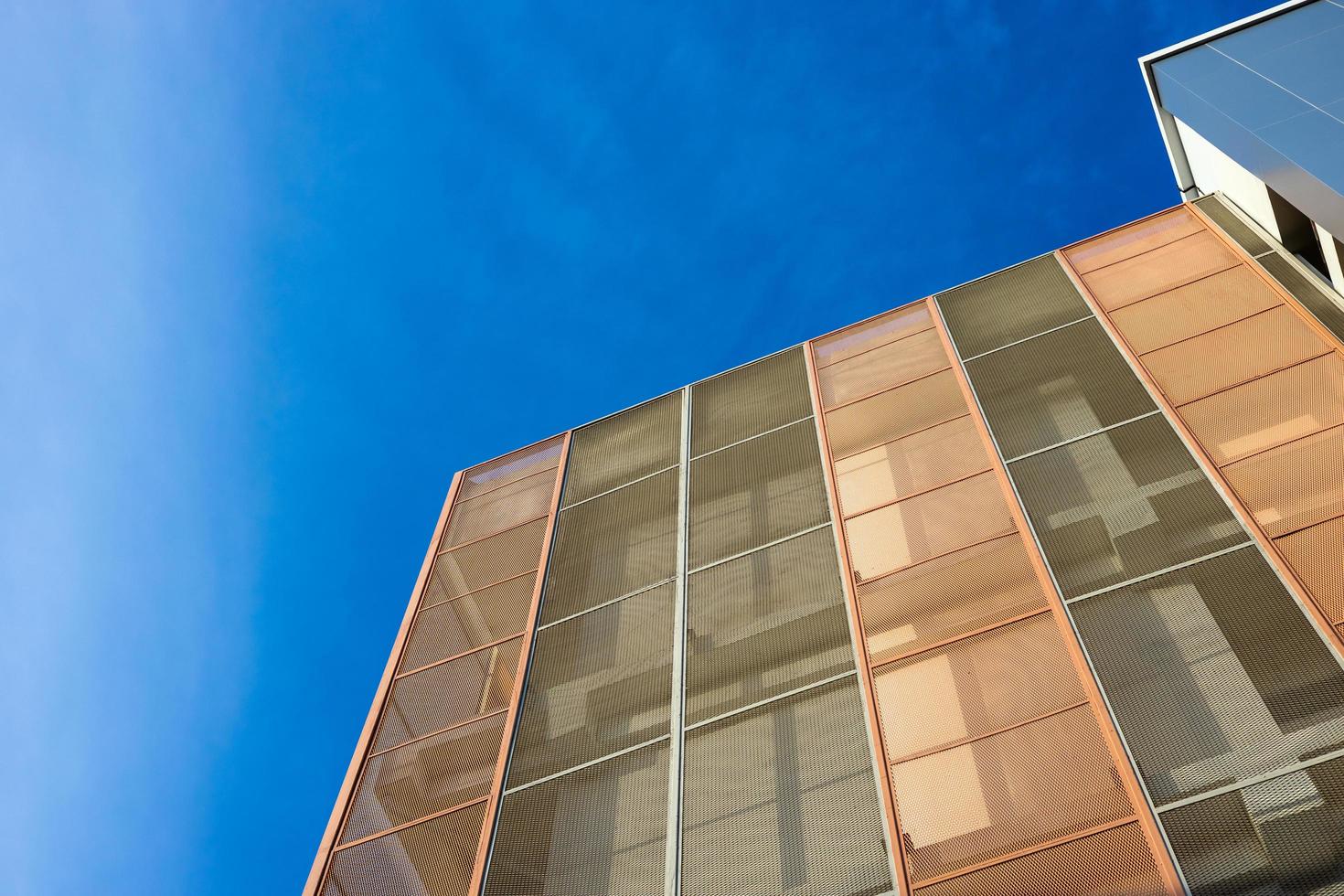 Low angle view, close-up of the new tenement building, which has installed a gray and orange steel mesh panel. photo