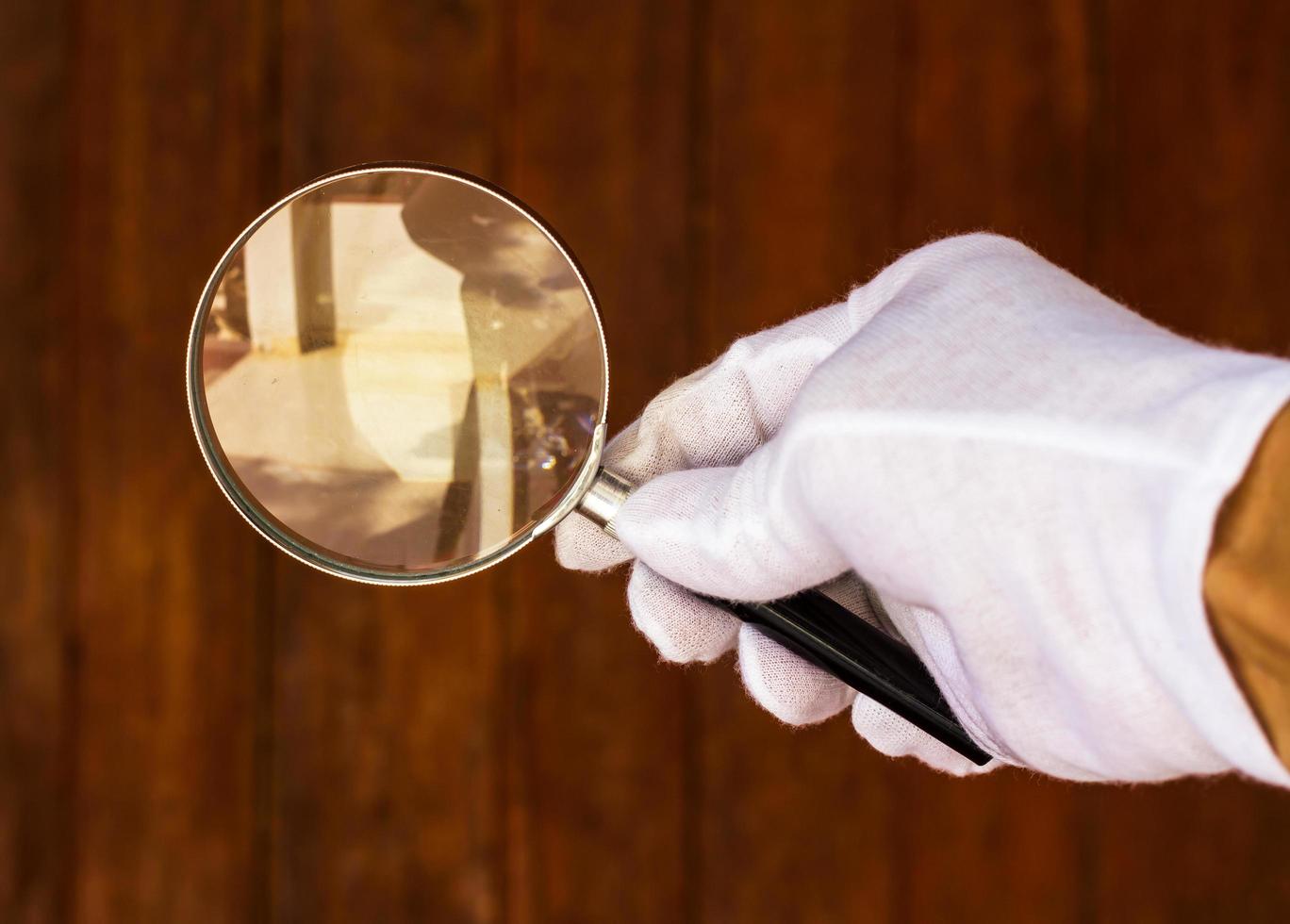 Magnifying glass with old wall. photo