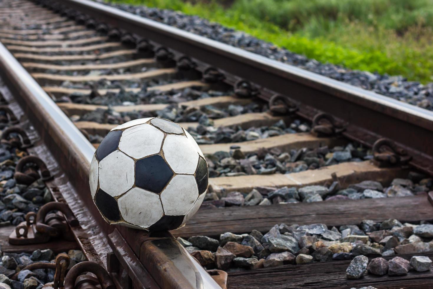 Close-old football on the tracks. photo