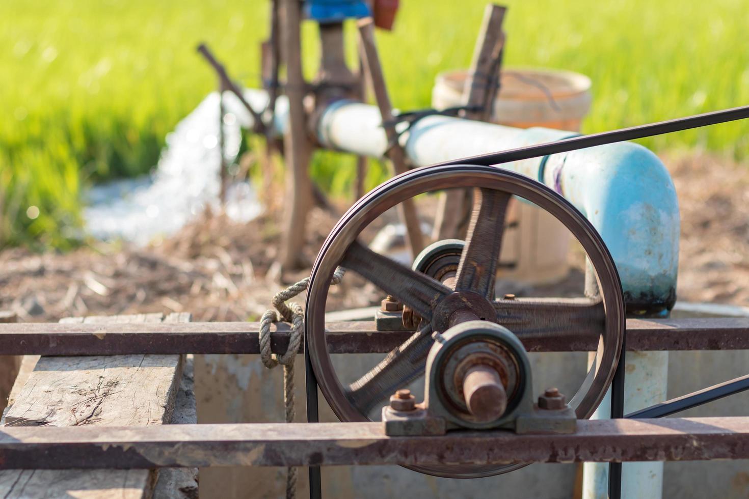 Old belt pulley is pumping groundwater. photo