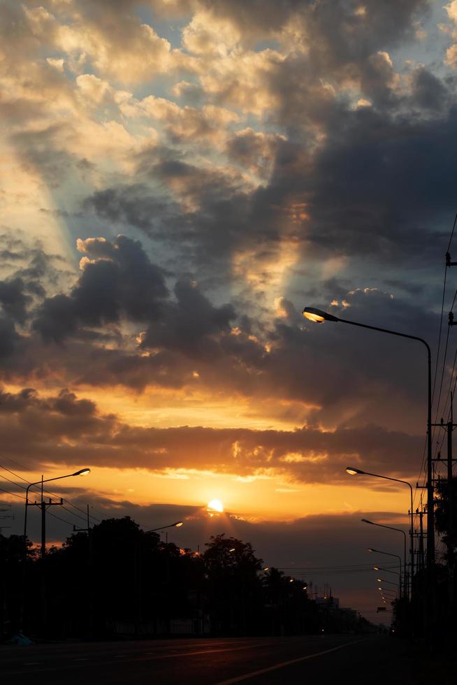 Cloudy sunrise over a dark street. photo