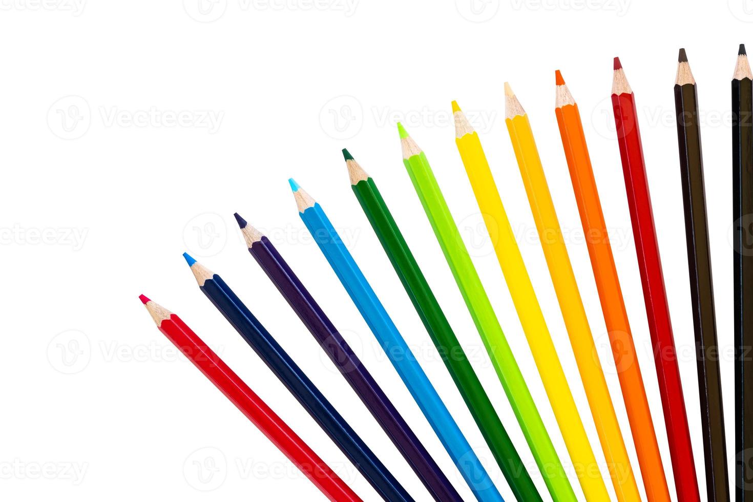 Many isolates of colored pencils are arranged in rows of hues spread out in a beautiful fan-shaped design like a rainbow on a white background. photo