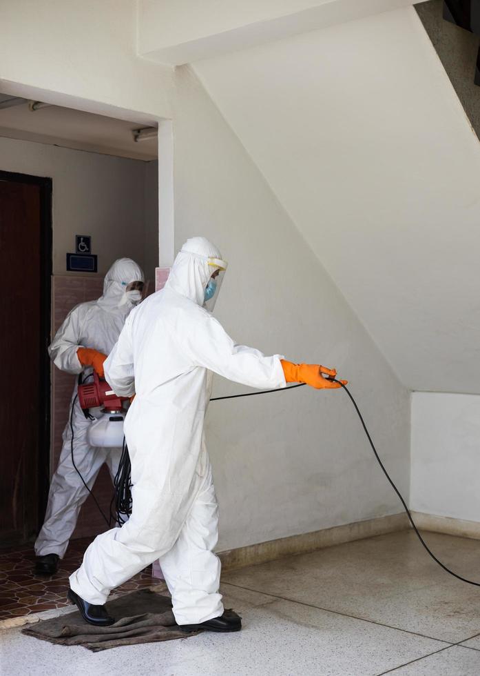 Both, wearing a PPE set, were sprayed to clean the toilet. photo