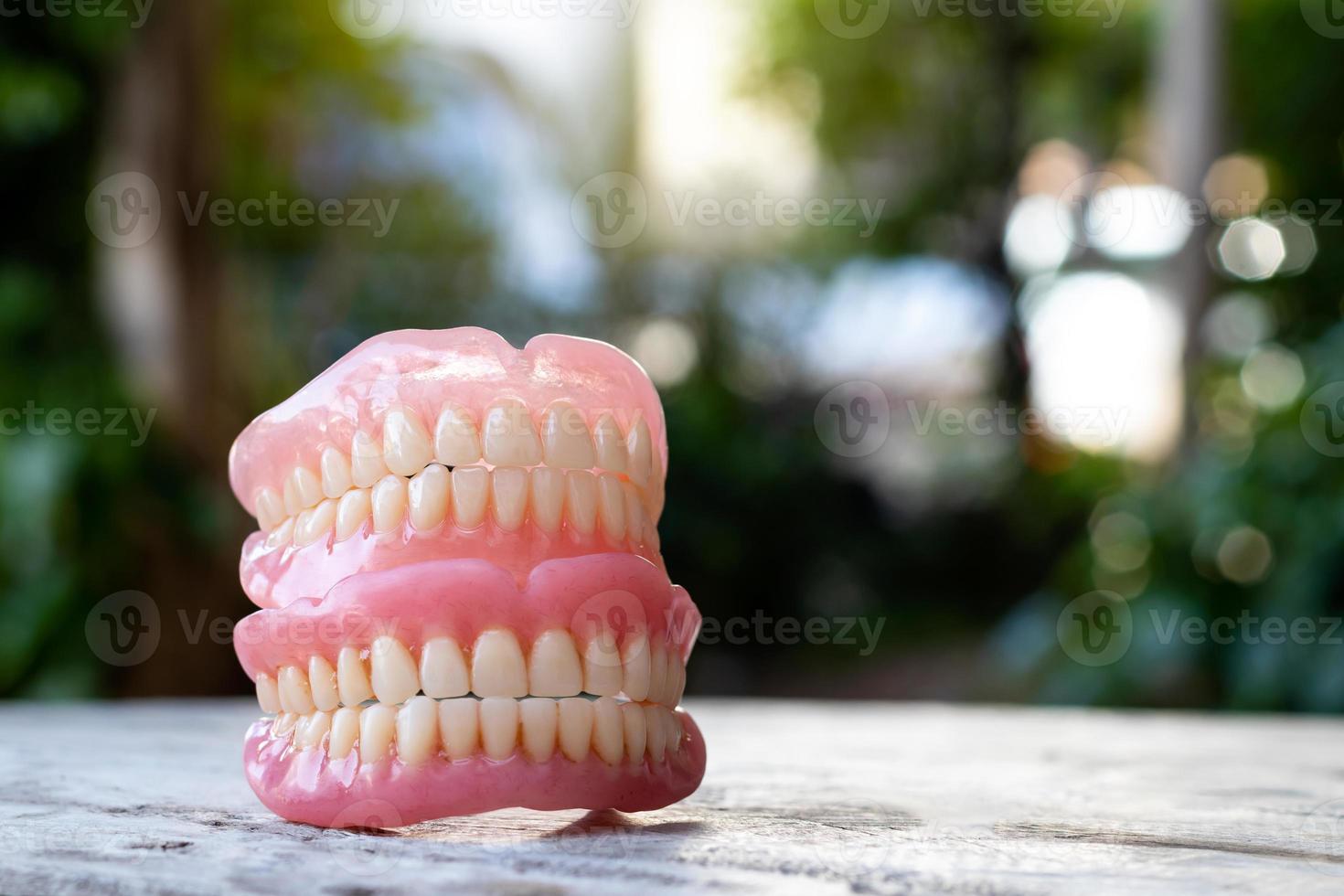 Dentures stacked with bokeh blur in a scene. photo