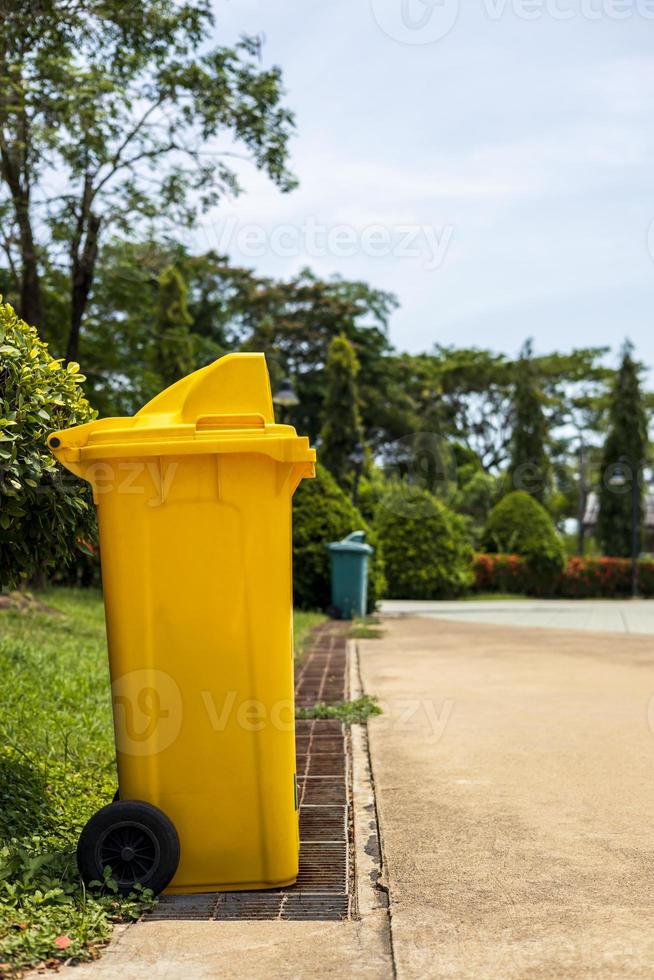 Yellow plastic bins located in the park. photo