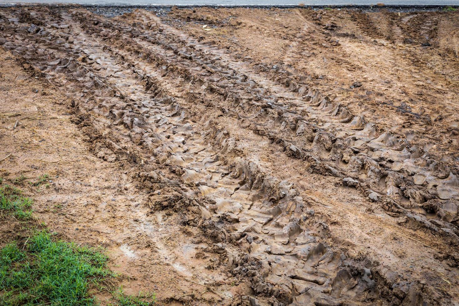 Big wheels traces on the muddy ground. photo