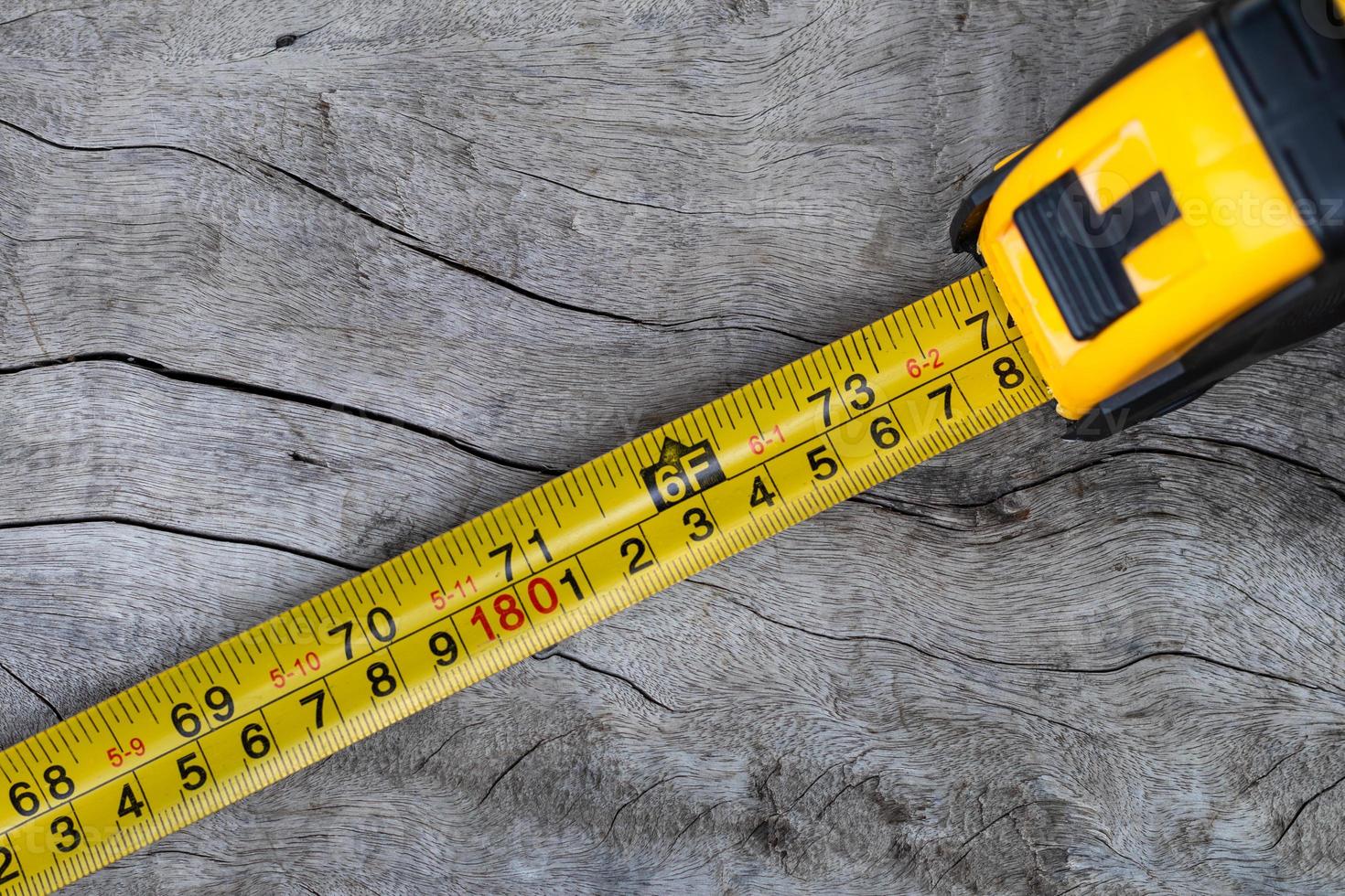 The 6-foot measuring tape put on the old wooden floor. photo