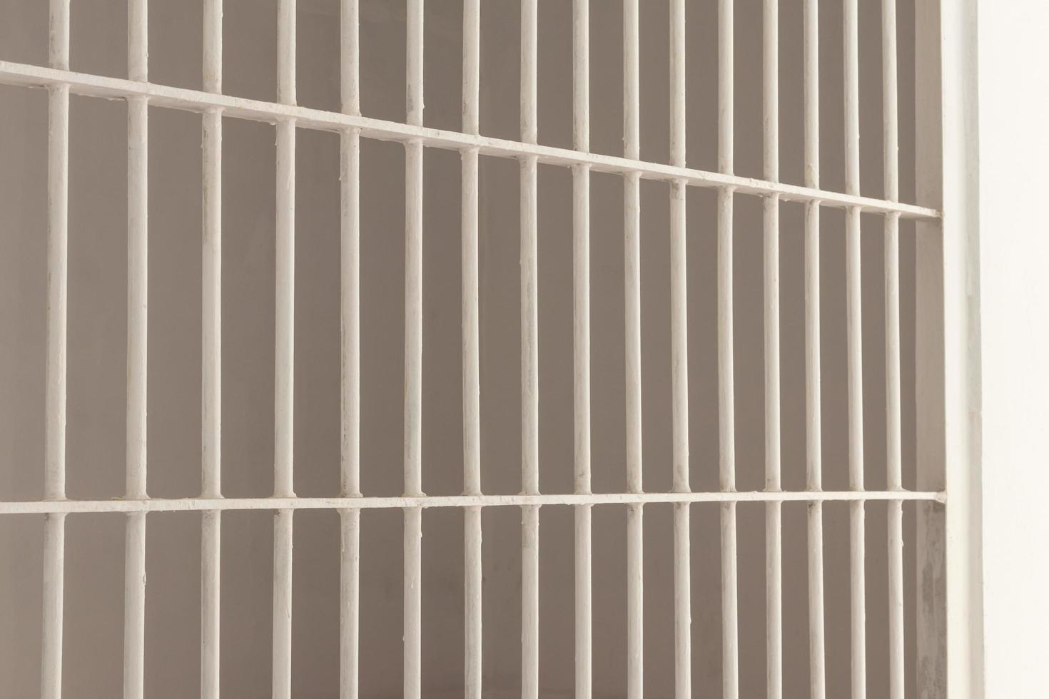 White steel bars inside a prison cell. photo