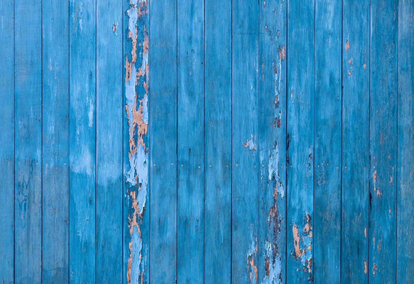 Old wooden fence background many blue vertical peeling. photo