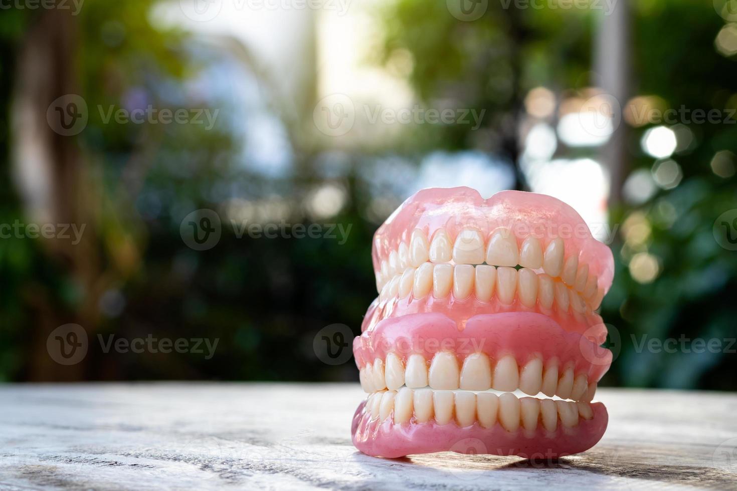 Dentures stacked with bokeh blur in a scene. photo