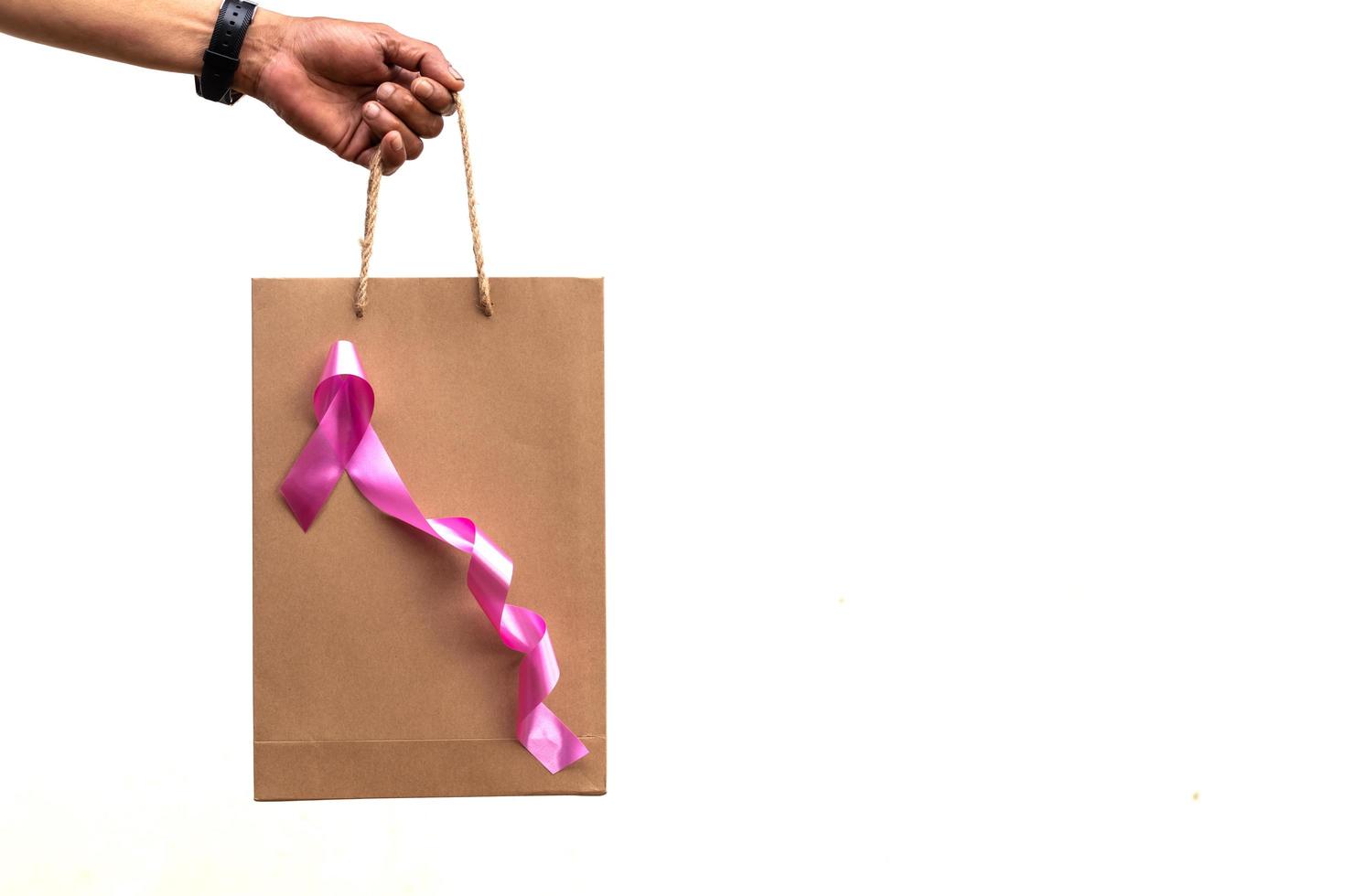 Breast cancer campaign symbol pink bow and paper bag. photo