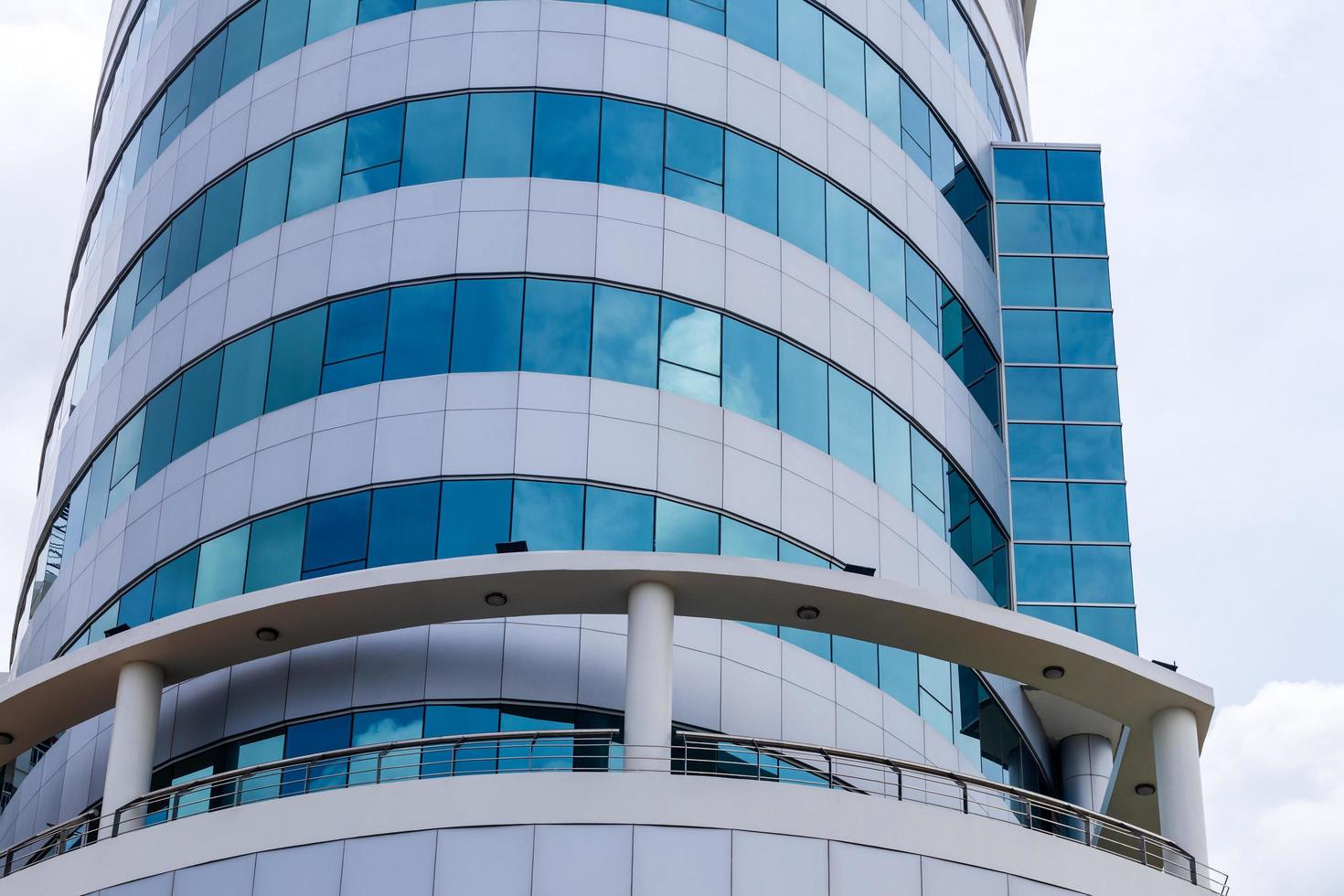 Circular building with lots of blue glass. photo