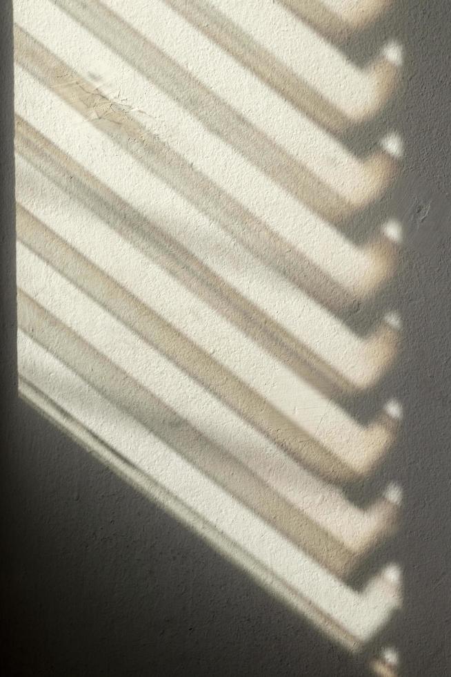 Dark shadows from the louver window to the concrete wall. photo