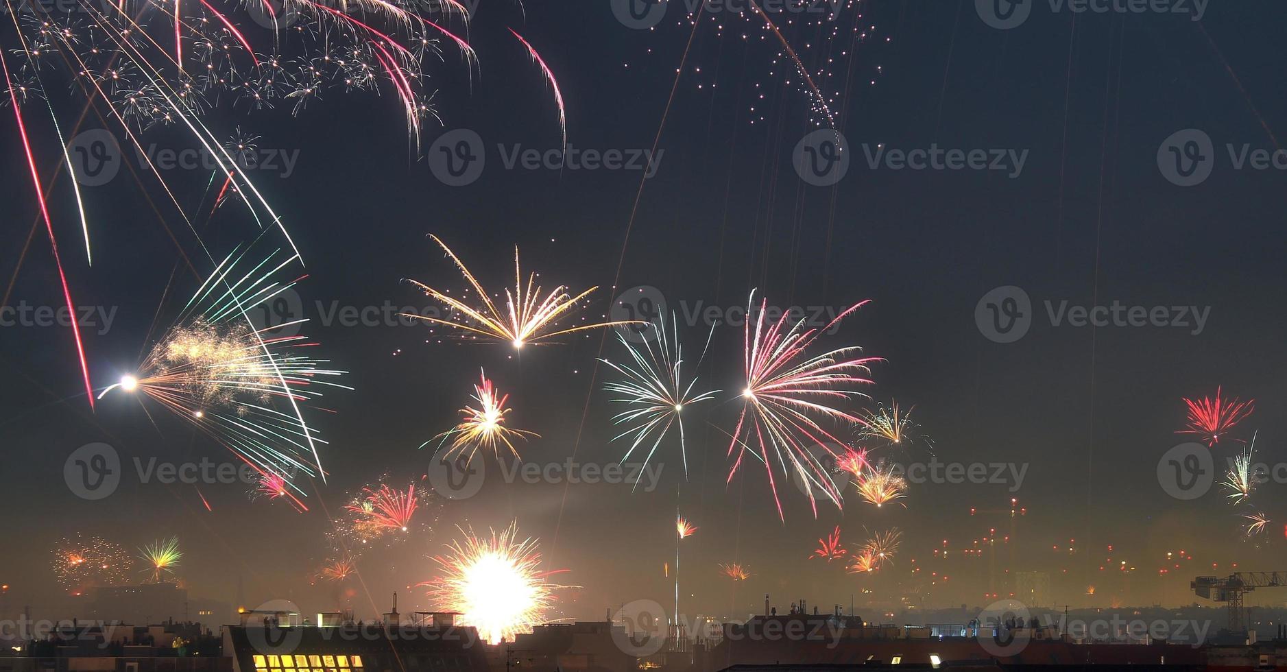 Long time exposure of fireworks over the roofs of vienna photo