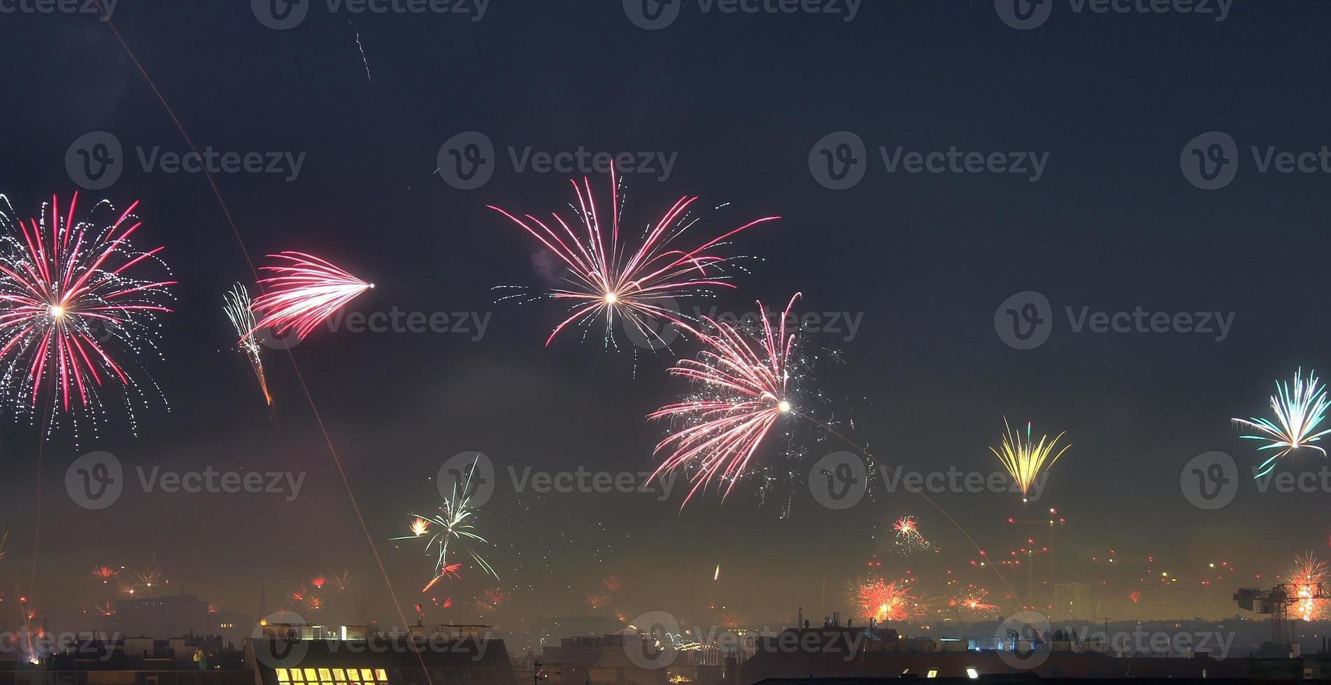 Long time exposure of fireworks over the roofs of vienna photo