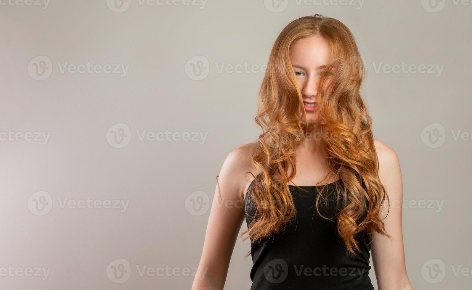 Portrait of beautiful cheerful redhead girl smiling laughing looking at camera over white background. photo