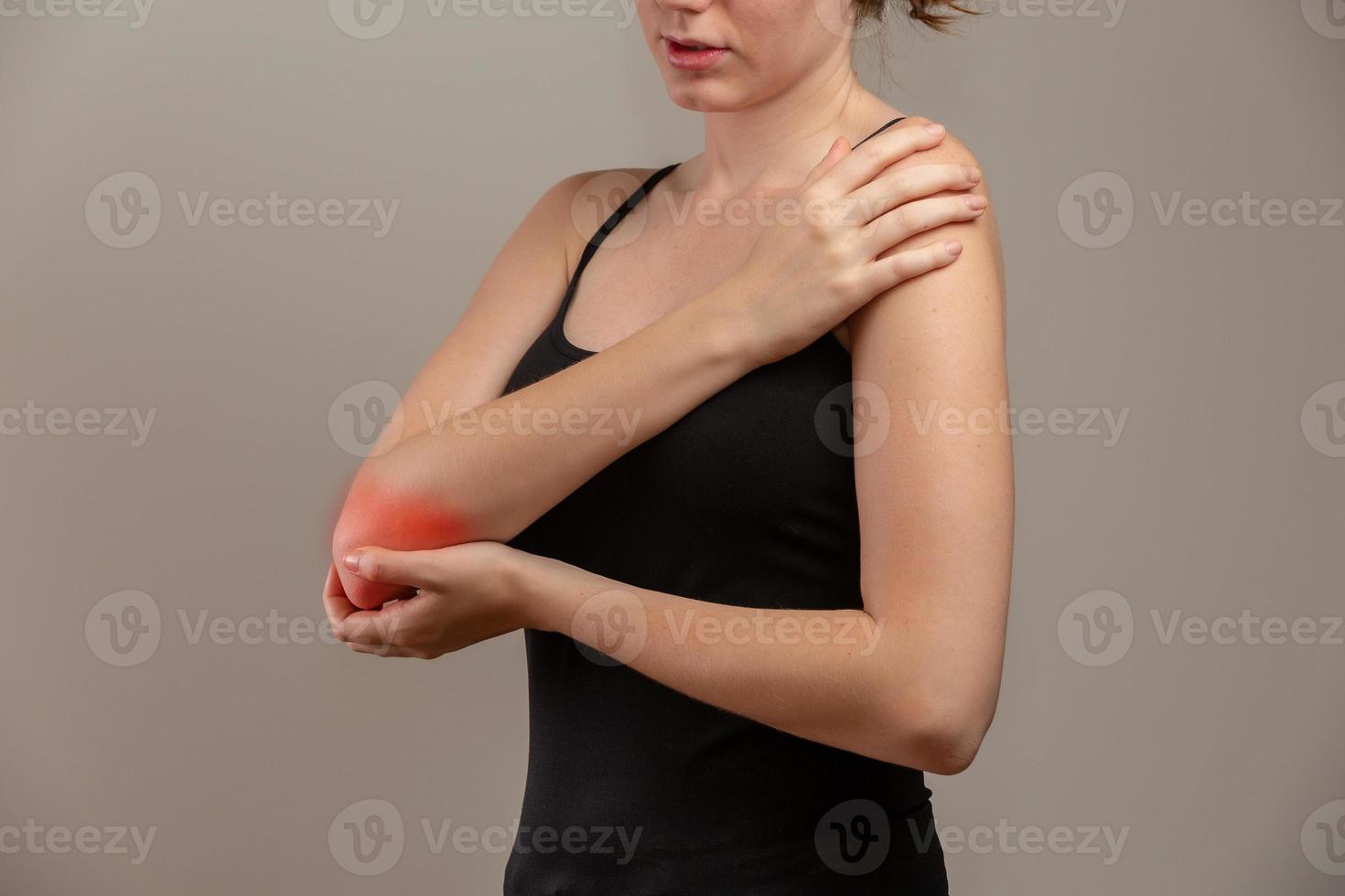 Redhead woman suffering from chronic joint rheumatism. Elbow pain and treatment concept. photo