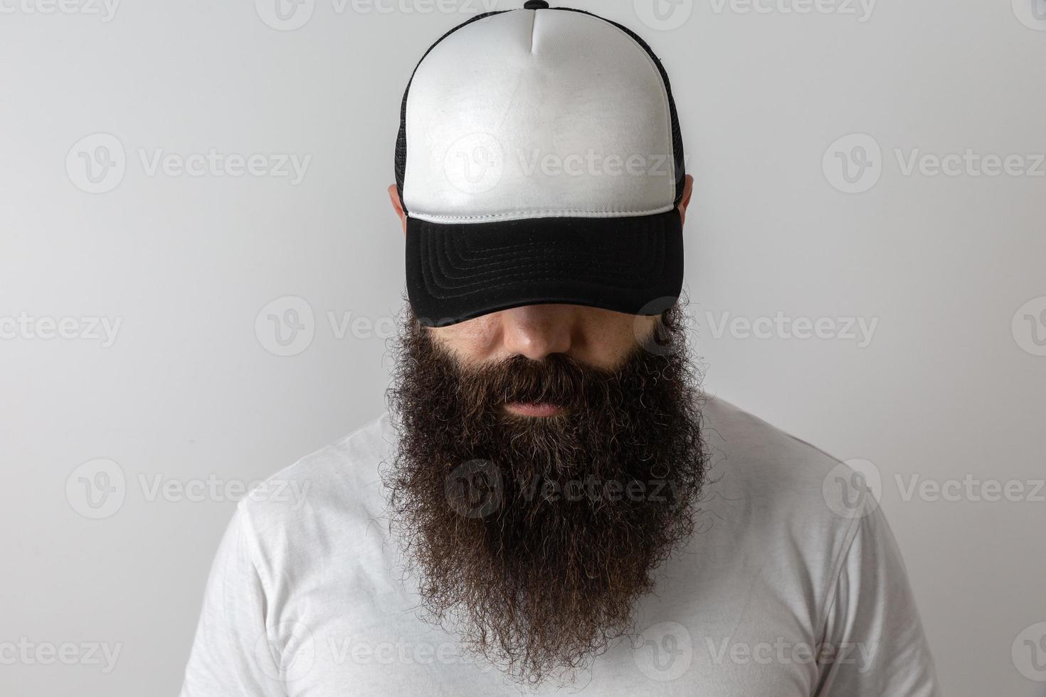 Hipster handsome male model with beard. Baseball cap with space for your logo photo